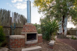 central Windhoek campsite – outdoor braai area beside trees