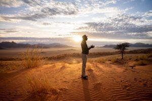 NamibRand accommodation – guest photographing the wide landscape