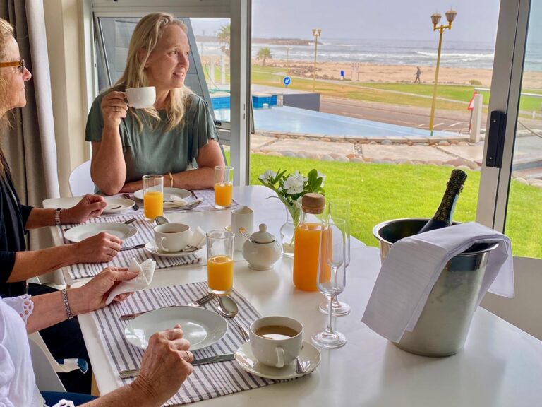 Swakopmund sea-view accommodation – guests enjoying breakfast by the sea
