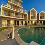 Namibia guesthouses: colourful beachfront exterior and curved pool at @ The Sea in Swakopmund