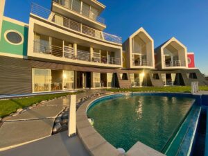 Namibia guesthouses: colourful beachfront exterior and curved pool at @ The Sea in Swakopmund