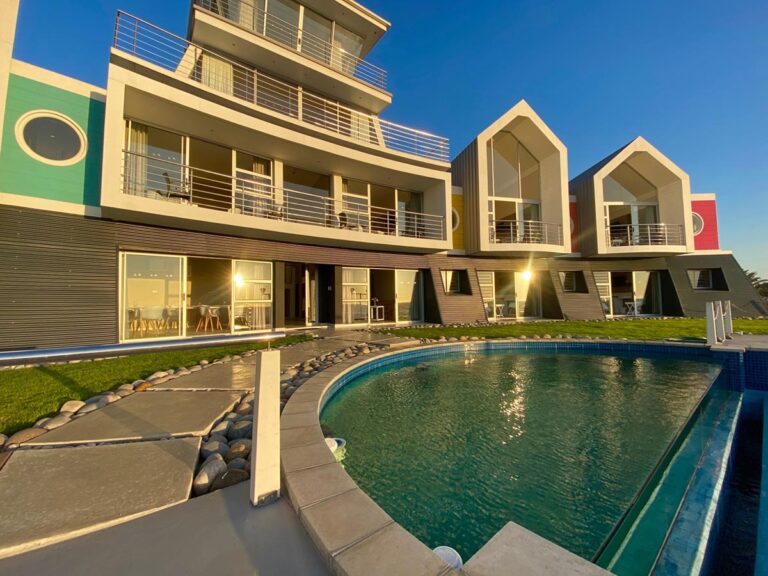 Namibia guesthouses: colourful beachfront exterior and curved pool at @ The Sea in Swakopmund
