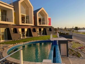 Swakopmund sea-view accommodation – infinity pool facing the ocean at sunset