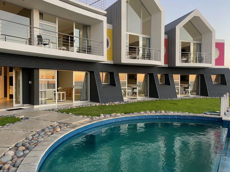 Swakopmund beachfront guesthouse – landscaped pool area beneath sea-view rooms