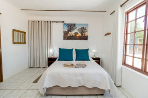 Grünau accommodation – bright double bedroom with blue accents