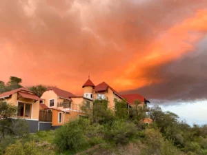 Ti Melen guesthouse in Windhoek beneath a dramatic sunset sky