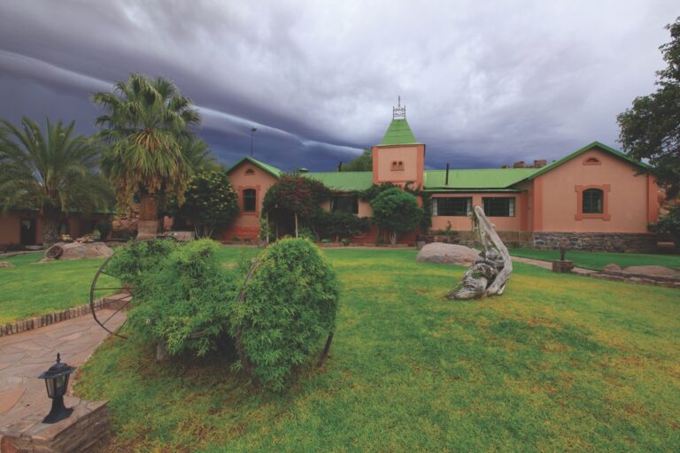 Garden and lodge buildings at Canyon Lodge accommodation