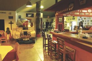 Bar and vintage vehicle displays at Canyon Roadhouse