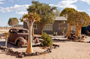 Vintage car beside Canyon Roadhouse guest buildings