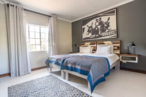 Twin-bed chalet room at Damara Mopane Lodge in Damaraland