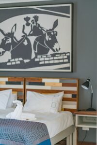 Twin beds and artwork in a Damara Mopane Lodge chalet