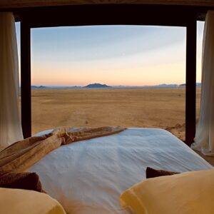 Bed overlooking the open Namib landscape at Desert Whisper