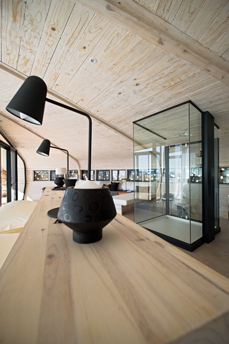 Open-plan lounge and fireplace at Desert Whisper