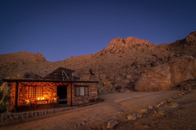 Stone chalet glowing at dusk near Aus