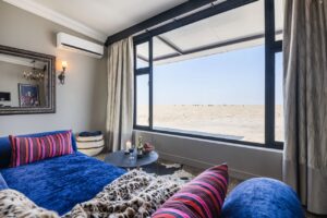 Etosha King Nehale bungalow lounge with an expansive plains view
