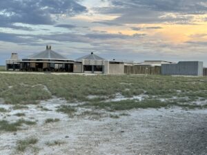 Etosha King Nehale lodge exterior across the Andoni Plains at sunset
