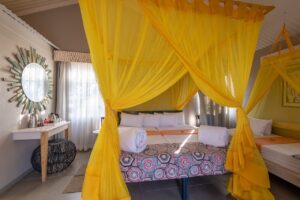 Double chalet room with yellow mosquito netting