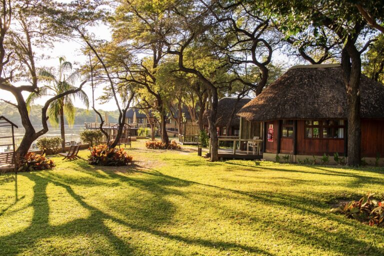 Shaded gardens and chalets at Hakusembe River Lodge