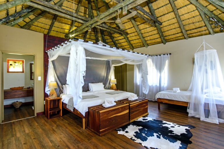 Family chalet with double and single beds at Hakusembe River Lodge