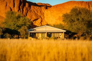 Namib Desert Lodge bungalow among golden grass