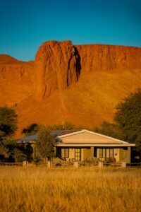 Namib Desert Lodge room exterior and dune backdrop