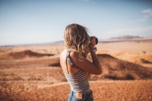 Traveller photographing desert scenery near Namib Desert Lodge