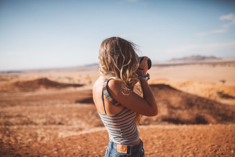 Traveller photographing desert scenery near Namib Desert Lodge