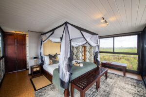 Mosquito-netted bedroom at Namushasha River Villa