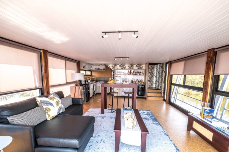 Open-plan lounge and kitchen at Namushasha River Villa
