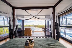 Namushasha River Villa bedroom opening onto a private river deck