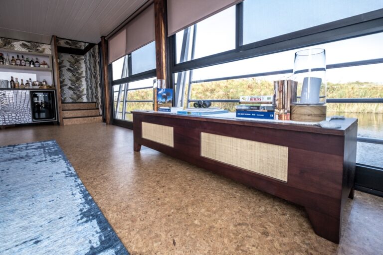 Low shelf and panoramic windows in the villa lounge