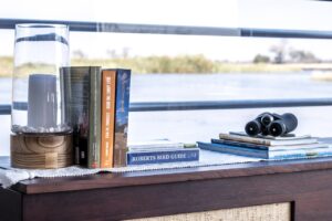 Birding books and binoculars at Namushasha River Villa