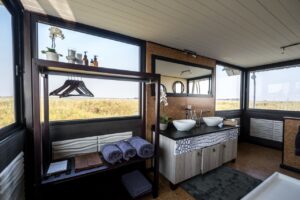 Bathroom vanity and guest robes at Namushasha River Villa