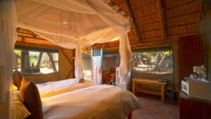Mosquito-netted bed in an Omarunga Epupa-Falls Camp room