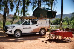 Four-wheel-drive camping setup at Omarunga Epupa-Falls Camp