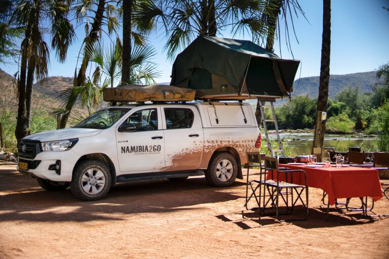 Four-wheel-drive camping setup at Omarunga Epupa-Falls Camp