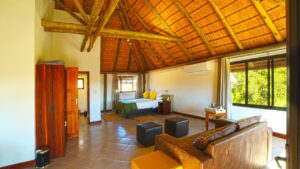 Guest room lounge and large windows at Palmwag Lodge