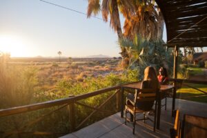 Guests enjoying a sunset view at Palmwag Lodge