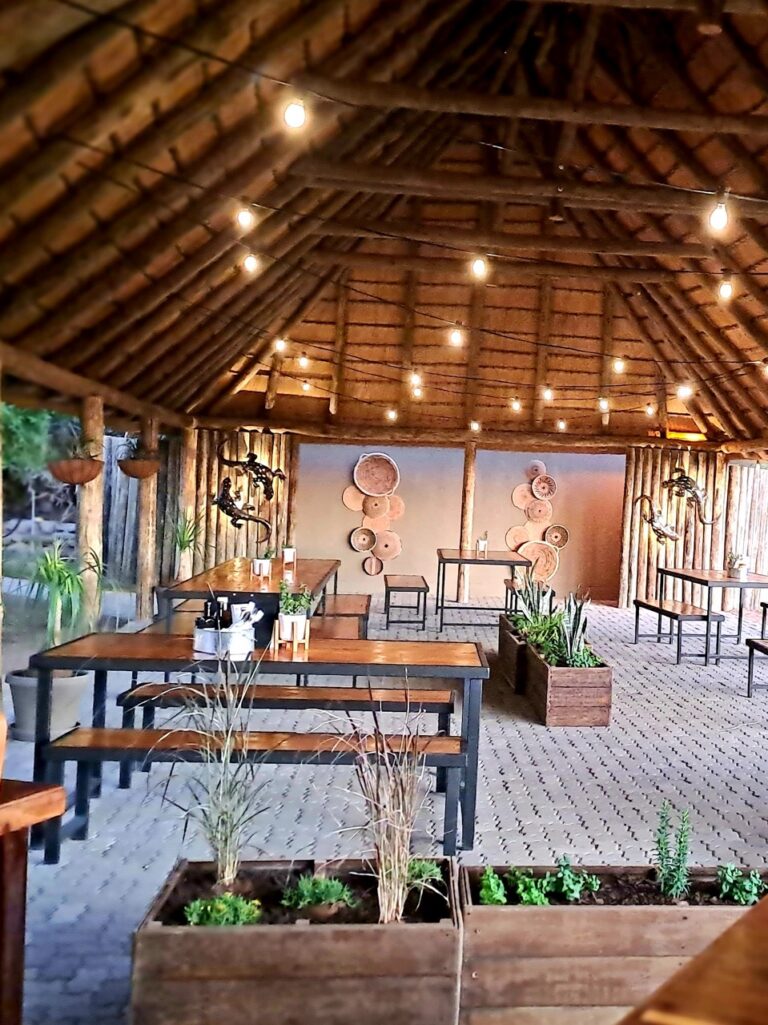 Palmwag Lodge restaurant with thatched roof and timber tables