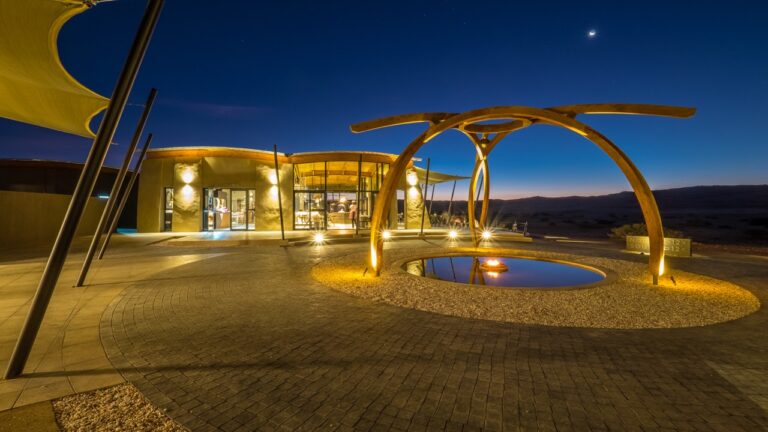 Illuminated lodge entrance at The Desert Grace