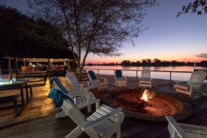 Fire pit on the riverside deck at Zambezi Mubala Camp after sunset
