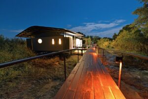 Illuminated walkway to a Zambezi Mubala Lodge bungalow