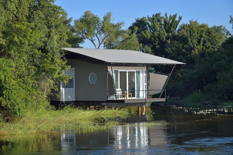 Guest bungalow reflected in the Zambezi River