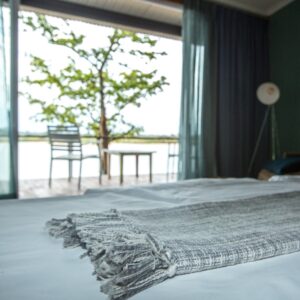 Bed in a Zambezi Mubala Lodge room overlooking the river