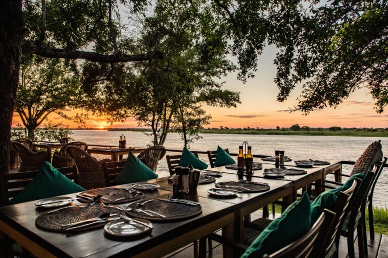 Outdoor dining table overlooking the Zambezi River at the lodge