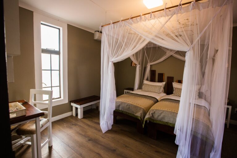Double room with mosquito net at Kalahari Anib Lodge