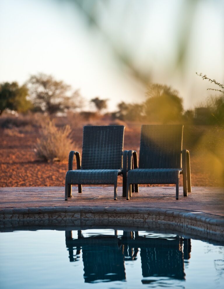 Two chairs facing the red dunes at Kalahari Anib Lodge