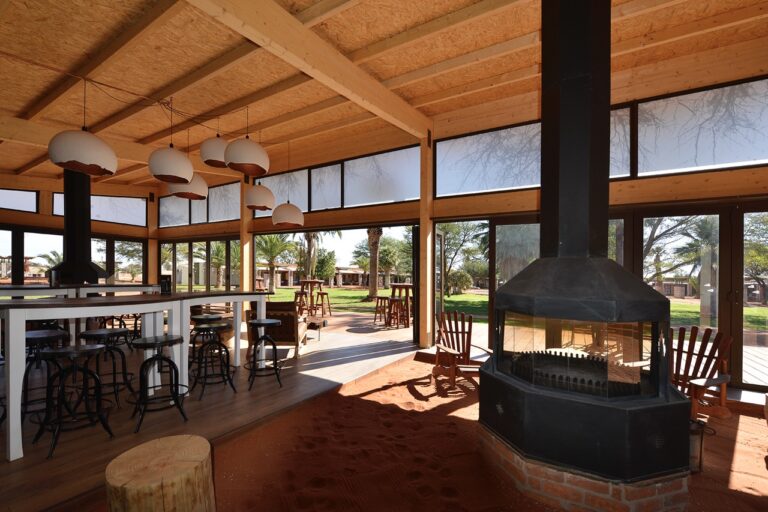 Open dining room and fireplace at Kalahari Anib Lodge