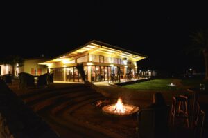 Main lodge and campfire at Kalahari Anib Lodge after dark