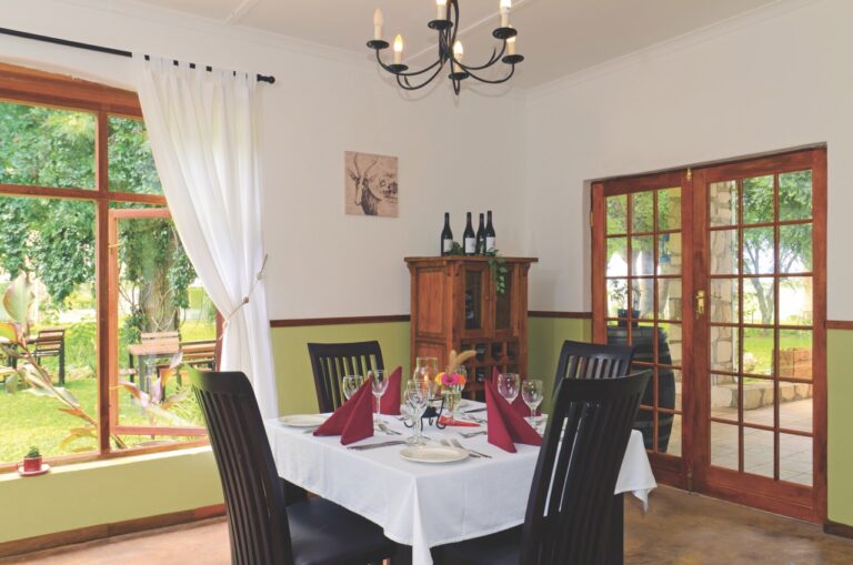 Restaurant table beside the garden at Kalahari Farmhouse